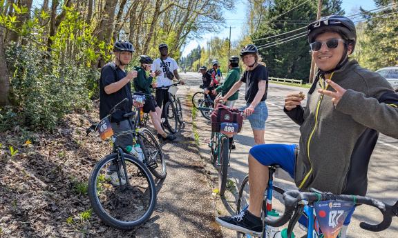Photo of 2025 MTP students taking a break under the trees while riding the Ride for Major Taylor