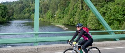 A woman rides across the bridge on Flying Wheels in 2025