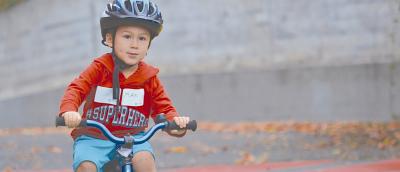 A youth riding a bicycle in a traffic garden
