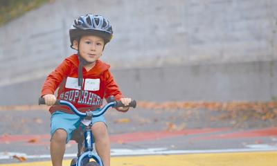 A youth riding a bicycle in a traffic garden