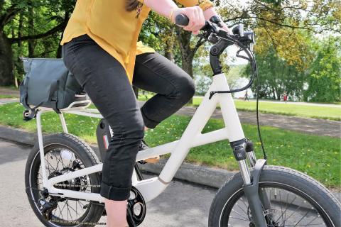 A person riding the REI CO-OP e1.1 low-step e-bike
