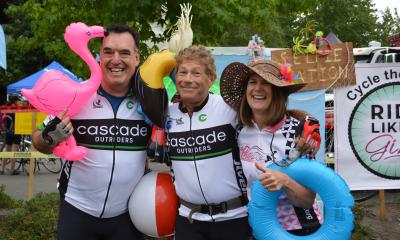 Three Outrider cyclists with inflatable pool toys