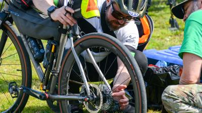 Two cyclists examining a wheel