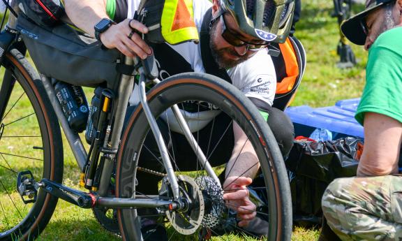 Two cyclists examining a wheel