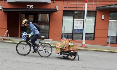 PRP volunteer pulling groceries up a hill