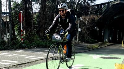 Tyler Vasquez riding in a protected bike lane