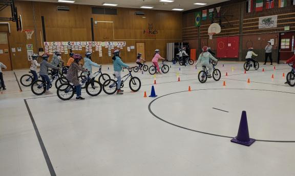 Photo of kids on bikes in Edmonds school gym