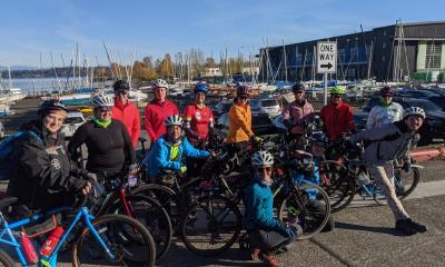 A group of women and non-binary riders gathers in Magnuson Park.