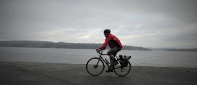 A person bikes in stormy weather. 