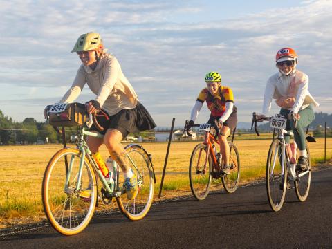 Three women ride together on STP 2025