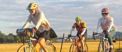 Three women ride together on STP 2025