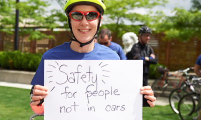 Bike rider holding poster