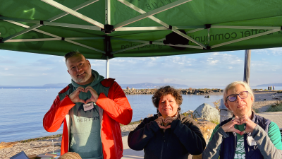 Volunteers making heart signs with their hands