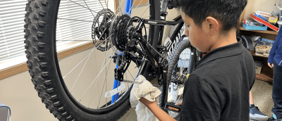 A participant from Children of the Valley in Mt. Vernon works on cleaning and lubing a chain as part of learning basic bike maintenance. August 5, 2025.