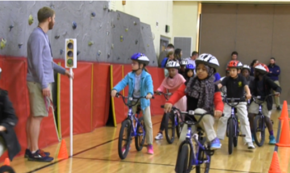 Kids on bikes at a playground stop light