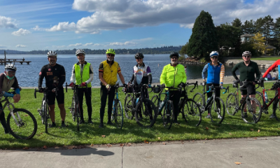 Multiple cyclists standing near Lake Washington