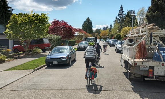 Group of cyclists riding on a greenway
