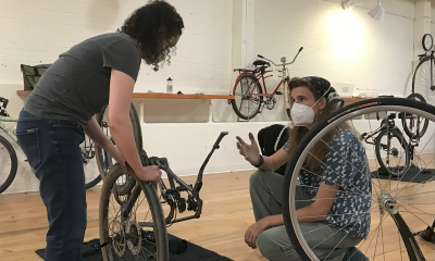 A student and instructor talk about bike maintenance at a WNB class.